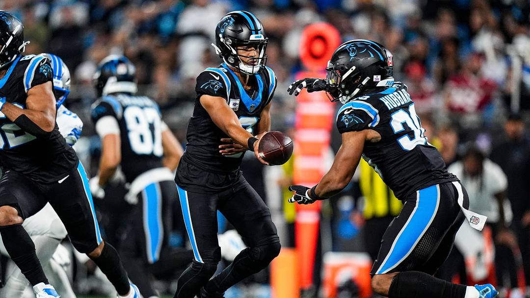 Carolina Panthers quarterback Bryce Young (9) hands the ball to running back Chuba Hubbard 