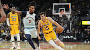 Nov 27, 2024; San Antonio, Texas, USA;  Los Angeles Lakers guard Austin Reaves (15) dribbles past San Antonio Spurs guard Stephon Castle (5) in the second half at Frost Bank Center. Mandatory Credit: Daniel Dunn-Imagn Images