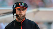 Nov 15, 2025; Miami Gardens, Florida, USA; against the Miami Hurricanes defensive coordinator Corey Hetherman watches from the sideline before the game against NC State Wolfpack at Hard Rock Stadium. Mandatory Credit: Sam Navarro-Imagn Images