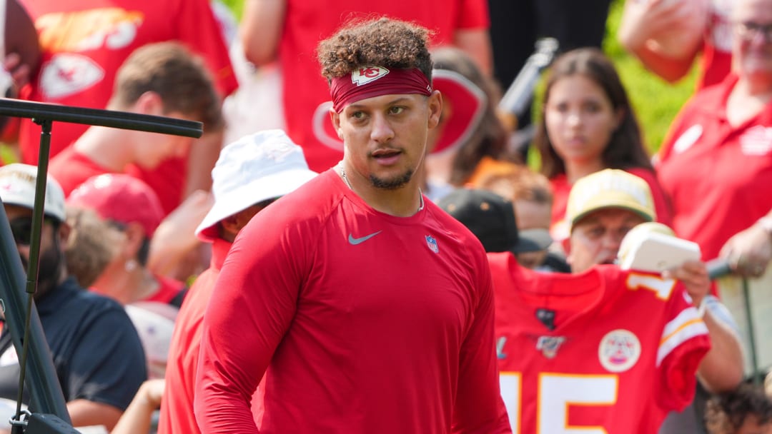 Jul 22, 2024; St. Joseph, MO, USA; Kansas City Chiefs quarterback Patrick Mahomes (15) signs autographs for fans after training camp at Missouri Western State University. Mandatory Credit: Denny Medley-USA TODAY Sports