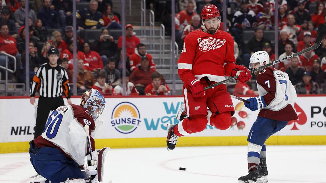 Feb 22, 2024; Detroit, Michigan, USA;  Detroit Red Wings center Dylan Larkin (71) tries to screen Colorado Avalanche goaltender Justus Annunen (60) in overtime at Little Caesars Arena. Mandatory Credit: Rick Osentoski-Imagn Images