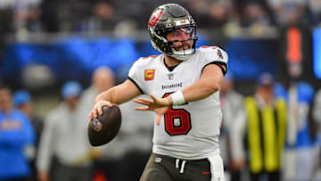 Dec 15, 2024; Inglewood, California, USA; Tampa Bay Buccaneers quarterback Baker Mayfield (6) moves out to pass against the Los Angeles Chargers during the first half at SoFi Stadium. Mandatory Credit: Gary A. Vasquez-Imagn Images