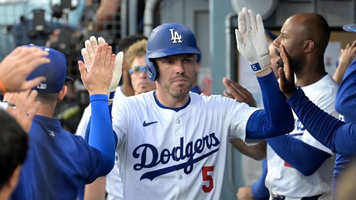 Aug 9, 2024; Los Angeles, California, USA; Los Angeles Dodgers first baseman Freddie Freeman (5) is congratulated in the dugout after a solo home run in the first inning against the Pittsburgh Pirates at Dodger Stadium. Mandatory Credit: Jayne Kamin-Oncea-USA TODAY Sports