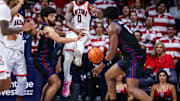 Dec 30, 2024; Tucson, Arizona, USA; Arizona Wildcats guard Jaden Bradley (0) loses control over the ball as TCU Horned Frogs guard Noah Reynolds (21) and TCU Horned Frogs center Ernest Udeh Jr. (8) attempt to grab the ball during the first half of the game at McKale Center. Mandatory Credit: Aryanna Frank-Imagn Images