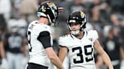 Jacksonville Jaguars place kicker Cam Little (39) kicks a field goal out of the hold of punter Logan Cooke (9) at Allegiant Stadium.