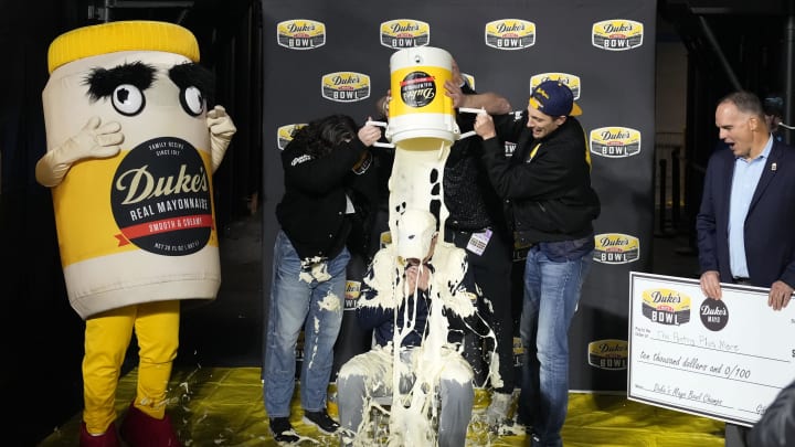 Dec 27, 2023; Charlotte, NC, USA; West Virginia Mountaineers head coach Neal Brown gets covered in mayonnaise after the game at Bank of America Stadium. Mandatory Credit: Bob Donnan-USA TODAY Sports