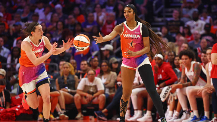 Jul 20, 2024; Phoenix, AZ, USA; Team WNBA forward Angel Reese (5) passes the ball to Team WNBA guard Caitlin Clark (22) during the first half against the USA Women's National Team at Footprint Center. 