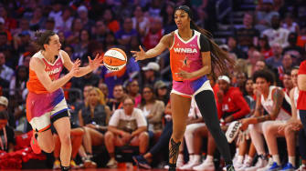 Team WNBA forward Angel Reese (5) passes the ball to Team WNBA guard Caitlin Clark.