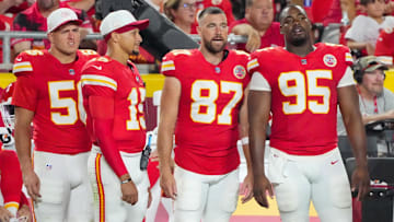 Aug 22, 2025; Kansas City, Missouri, USA; Kansas City Chiefs defensive end George Karlaftis (56) and quarterback Patrick Mahomes (15) and tight end Travis Kelce (87) and defensive tackle Chris Jones (95) watch play against the Chicago Bears during the second half of the game at GEHA Field at Arrowhead Stadium. Mandatory Credit: Denny Medley-Imagn Images