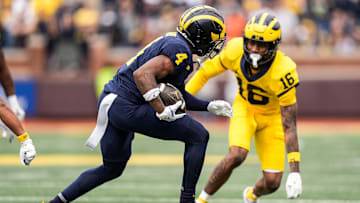 Team Blue wide receiver Andrew Marsh (4) runs against Team Maize defensive back Jo'Ziah Edmond (16) during the second half of the spring game at Michigan Stadium in Ann Arbor on Saturday, April 19, 2025.