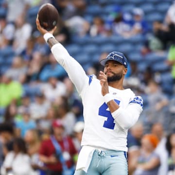 Dallas Cowboys quarterback Dak Prescott throws with quarterback Will Grier.