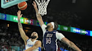 Aug 10, 2024; Paris, France; France shooting guard Evan Fournier (10) shoots against United States centre Anthony Davis (14) in the second half in the men's basketball gold medal game during the Paris 2024 Olympic Summer Games at Accor Arena. Mandatory Credit: Kyle Terada-Imagn Images