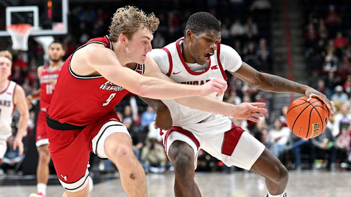 Nov 21, 2024; Spokane, Washington, USA; Washington State Cougars guard Cedric Coward (0) controls the ball against Eastern Washington Eagles guard Andrew Cook (9) in the first half at Spokane Veterans Memorial Arena. Mandatory Credit: James Snook-Imagn Images