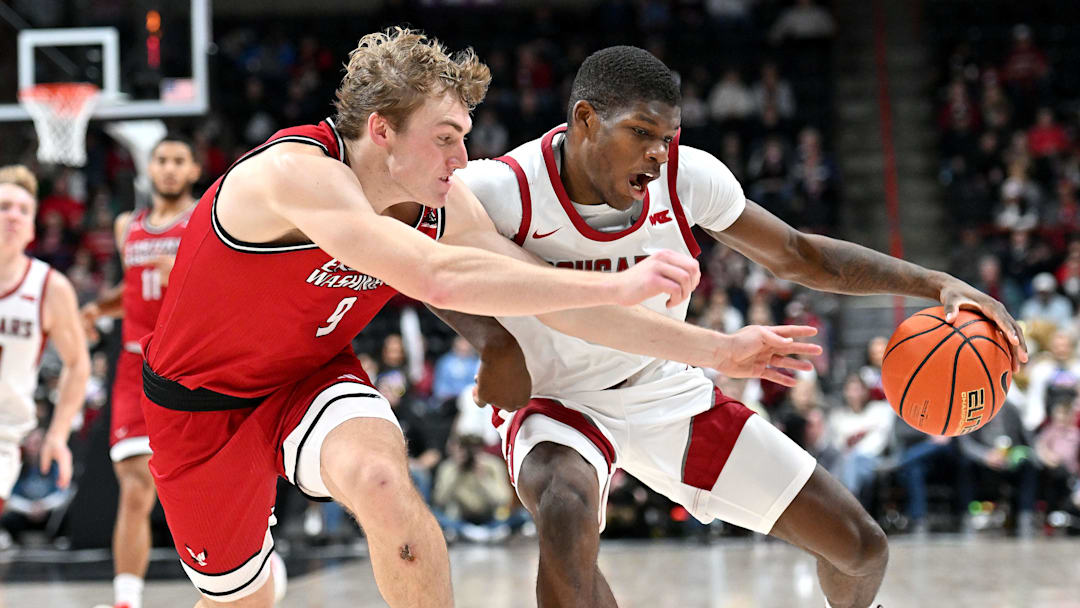 Nov 21, 2024; Spokane, Washington, USA; Washington State Cougars guard Cedric Coward (0) controls the ball against Eastern Washington Eagles guard Andrew Cook (9) in the first half at Spokane Veterans Memorial Arena. Mandatory Credit: James Snook-Imagn Images