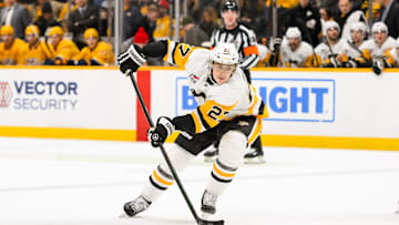 Dec 19, 2024; Nashville, Tennessee, USA;  Pittsburgh Penguins defenseman Ryan Graves (27) skates with the puck against the Nashville Predators during the second period at Bridgestone Arena. Mandatory Credit: Steve Roberts-Imagn Images