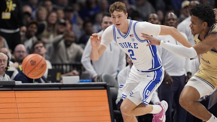 Mar 13, 2025; Charlotte, NC, USA;  Duke Blue Devils forward Cooper Flagg (2) and Georgia Tech Yellow Jackets guard Jaeden Mustaf (3) chase the loose ball during the first half at Spectrum Center. Mandatory Credit: Jim Dedmon-Imagn Images