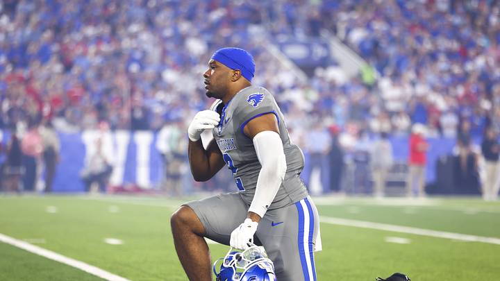 Sep 14, 2024; Lexington, Kentucky, USA; Kentucky Wildcats linebacker Jamon Dumas-Johnson (2) makes the sign of the cross while taking a knee before the game against Georgia Bulldogs at Kroger Field. Georgia won 13-12. Mandatory Credit: Carter Skaggs-Imagn Images