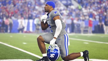 Sep 14, 2024; Lexington, Kentucky, USA; Kentucky Wildcats linebacker Jamon Dumas-Johnson (2) makes the sign of the cross while taking a knee before the game against Georgia Bulldogs at Kroger Field. Georgia won 13-12. Mandatory Credit: Carter Skaggs-Imagn Images