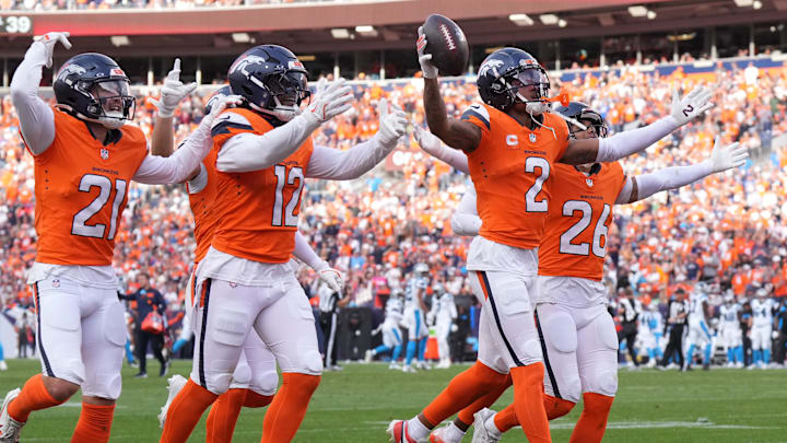 Oct 27, 2024; Denver, Colorado, USA; Denver Broncos cornerback Pat Surtain II (2) celebrates his interception with cornerback Riley Moss (21) and linebacker Kwon Alexander (12) and safety Devon Key (26) in the third quarter against the Carolina Panthers at Empower Field at Mile High. Oct 27, 2024; Denver, Colorado, USA; Denver Broncos cornerback Pat Surtain II (2) celebrates his interception with cornerback Riley Moss (21) and linebacker Kwon Alexander (12) and safety Devon Key (26) in the third quarter against the Carolina Panthers at Empower Field at Mile High.
