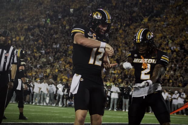 Missouri Tigers quarterback Brady Cook (12) celebrates with receiver Marquis Johnson (2) after scoring a touchdown. 