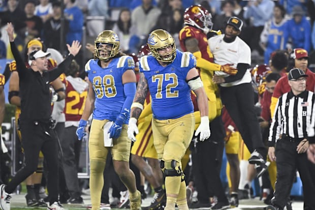 UCLA Bruins tight end Moliki Matavao (88) and UCLA Bruins offensive lineman Garrett DiGiorgio (72) walks off the field.