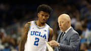 Nov 3, 2025; Los Angeles, California, USA;  UCLA Bruins head coach Mick Cronin talks to guard Donovan Dent (2) during the second half against the Eastern Washington Eagles at Pauley Pavilion presented by Wescom Financial. Mandatory Credit: Kiyoshi Mio-Imagn Images