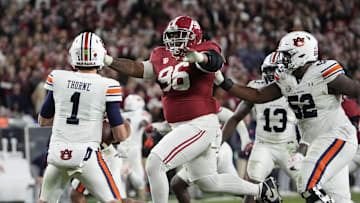Nov 30, 2024; Tuscaloosa, Alabama, USA;  Auburn Tigers quarterback Payton Thorne (1) throws under pressure from Alabama Crimson Tide defensive lineman Tim Keenan III (96) during the second half at Bryant-Denny Stadium. Alabama won 28-14. Mandatory Credit: Gary Cosby Jr.-Imagn Images