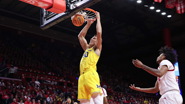Michigan Wolverines center Vladislav Goldin (50) dunks the ball during the first half