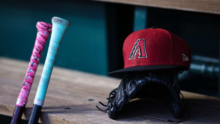 Jun 7, 2023; Washington, District of Columbia, USA; A general view of an Arizona Diamondbacks hat, glove, and bats in the dugout during the fifth inning of the game against the Washington Nationals at Nationals Park. Mandatory Credit: Scott Taetsch-Imagn Images