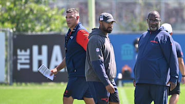 Jul 28, 2025; Foxborough, MA, USA; New England Patriots head coach Mike Vrabel (red sleeves and defensive coordinator Terrell Williams (blue pants) watch the team during training camp at Gillette Stadium. Mandatory Credit: Eric Canha-Imagn Images