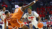 Jan 29, 2025; Oxford, Mississippi, USA; Mississippi Rebels guard Matthew Murrell (11) drives to the basket as Texas Longhorns forward Ze'Rik Onyema (21) defends during the second half at The Sandy and John Black Pavilion at Ole Miss. Mandatory Credit: Petre Thomas-Imagn Images