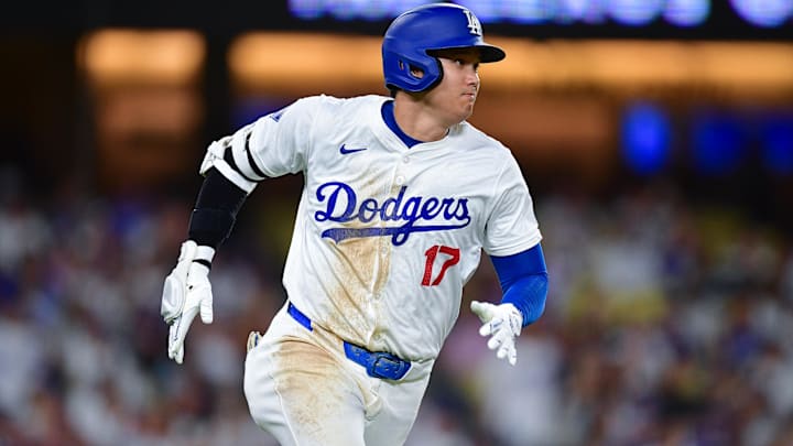 Sep 9, 2024; Los Angeles, California, USA; Los Angeles Dodgers designated hitter Shohei Ohtani (17) runs after hitting a single against the Chicago Cubs during the seventh inning at Dodger Stadium. Mandatory Credit: Gary A. Vasquez-Imagn Images