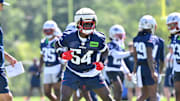 Jul 23, 2025; Foxborough, MA, USA; New England Patriots defensive end Truman Jones (54) warms up as head coach Mike Vrabel watches during day one of training camp at Gillette Stadium. Mandatory Credit: Eric Canha-Imagn Images