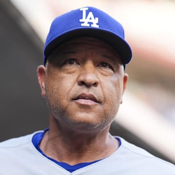 Jul 29, 2025; Cincinnati, Ohio, USA;  Los Angeles Dodgers manager Dave Roberts (30) stands in the dugout before the game against the Cincinnati Reds at Great American Ball Park. Mandatory Credit: Aaron Doster-Imagn Images