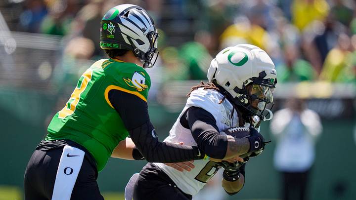 Fighting Ducks quarterback Dylan Raiola, left, hands off the ball to Fighting Ducks running back Dierre Hill Jr. during the Oregon Ducks annual spring game on April 25, 2026 at Autzen Stadium in Eugene, Oregon.