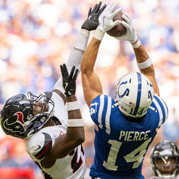 Sep 8, 2024; Indianapolis, Indiana, USA; Indianapolis Colts wide receiver Alec Pierce (14) catches a long pass under coverage from Houston Texans safety Jimmie Ward (20) during the second half at Lucas Oil Stadium. Mandatory Credit: Marc Lebryk-Imagn Images