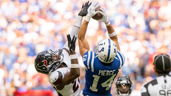 Sep 8, 2024; Indianapolis, Indiana, USA; Indianapolis Colts wide receiver Alec Pierce (14) catches a long pass under coverage from Houston Texans safety Jimmie Ward (20) during the second half at Lucas Oil Stadium. Mandatory Credit: Marc Lebryk-Imagn Images