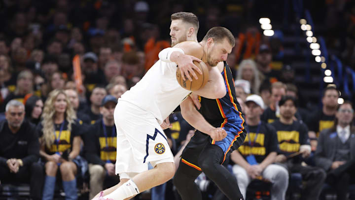 Denver Nuggets center Nikola Jokic (15) drives as Oklahoma City Thunder center Isaiah Hartenstein (55) defends in the second half during game two of the second round for the 2025 NBA Playoffs at Paycom Center. Denver Nuggets center Nikola Jokic (15) drives as Oklahoma City Thunder center Isaiah Hartenstein (55) defends in the second half during game two of the second round for the 2025 NBA Playoffs at Paycom Center.