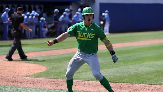 Oregon outfielder Bryce Boettcher (28) reacts after hitting a solo home run in the top of the eleventh inning