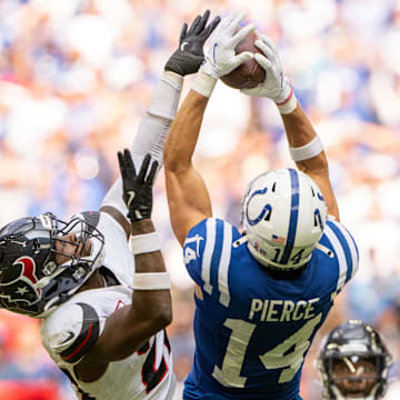 Sep 8, 2024; Indianapolis, Indiana, USA; Indianapolis Colts wide receiver Alec Pierce (14) catches a long pass under coverage from Houston Texans safety Jimmie Ward (20) during the second half at Lucas Oil Stadium. Mandatory Credit: Marc Lebryk-Imagn Images