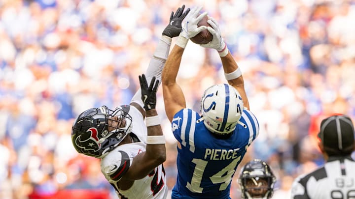 Sep 8, 2024; Indianapolis, Indiana, USA; Indianapolis Colts wide receiver Alec Pierce (14) catches a long pass under coverage from Houston Texans safety Jimmie Ward (20) during the second half at Lucas Oil Stadium. Mandatory Credit: Marc Lebryk-Imagn Images