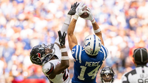 Colts receiver Alec Pierce (blue jersey; white helmet) makes an acrobatic catch against defenders. 