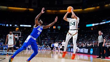 Mar 17, 2023; Albany, NY, USA; Miami Hurricanes guard Nijel Pack (24) attempts a shot as Drake Bulldogs guard Sardaar Calhoun (14) defends in the second half at MVP Arena. Mandatory Credit: Gregory Fisher-Imagn Images