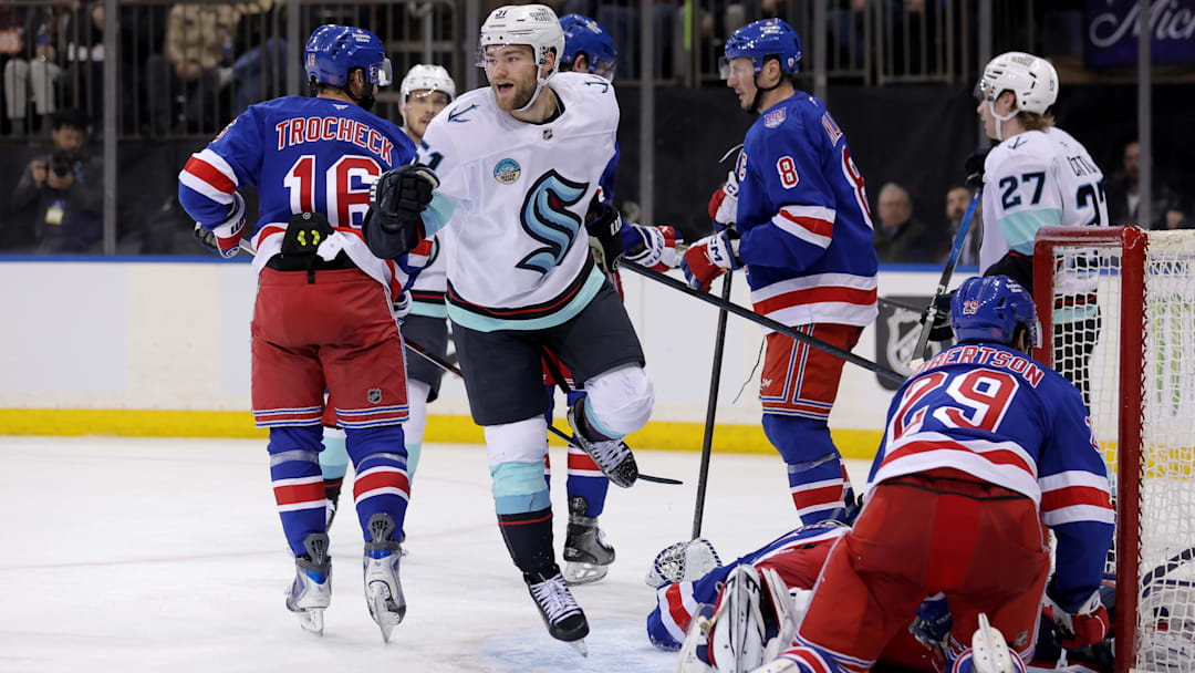 Jan 12, 2026; New York, New York, USA; Seattle Kraken center Shane Wright (51) celebrates his goal against New York Rangers goaltender Jonathan Quick (32) and defenseman Matthew Robertson (29) during the third period at Madison Square Garden. Mandatory Credit: Brad Penner-Imagn Images