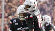 Sep 13, 2025; Cincinnati, Ohio, USA;  Cincinnati Bearcats wide receiver Caleb Goodie (10) celebrates with quarterback Brendan Sorsby (2) after scoring a touchdown against the Northwestern State Demons in the first half at Nippert Stadium. Mandatory Credit: Aaron Doster-Imagn Images