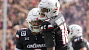 Sep 13, 2025; Cincinnati, Ohio, USA;  Cincinnati Bearcats wide receiver Caleb Goodie (10) celebrates with quarterback Brendan Sorsby (2) after scoring a touchdown against the Northwestern State Demons in the first half at Nippert Stadium. Mandatory Credit: Aaron Doster-Imagn Images