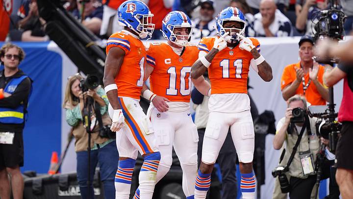Oct 26, 2025; Denver, Colorado, USA;  Denver Broncos wide receiver Troy Franklin (11) celebrates with wide receiver Courtland Sutton (14) and quarterback Bo Nix (10) after scoring a touchdown against the Dallas Cowboys in the fourth quarter at Empower Field at Mile High. Mandatory Credit: Ron Chenoy-Imagn Images