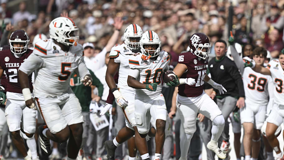 Hurricanes wide receiver Malachi Toney returns a punt against the Aggies during first half of their first-round CFP game.