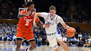 Jan 14, 2025; Durham, North Carolina, USA; Duke Blue Devils forward Cooper Flagg (2) drives to the basket as Miami Hurricanes forward Brandon Johnson (2) defends during the second half at Cameron Indoor Stadium. Mandatory Credit: Rob Kinnan-Imagn Images