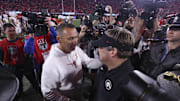 Athens, Georgia, USA; Texas Longhorns head coach Steve Sarkisian and Georgia Bulldogs head coach Kirby Smart interact after a game at Sanford Stadium.